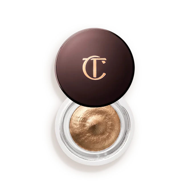 Shimmery golden cream eyeshadow in a round jar with a dark brown lid and gold logo